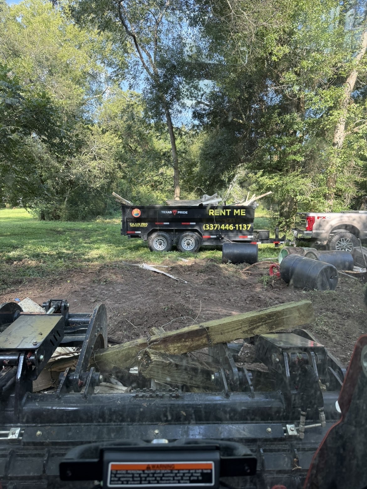 View from the loader as the Cajun Pro trailer takes on demolition debris